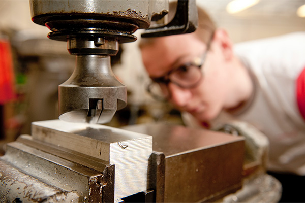 A Motorsport student works on machinery in the engineering workshop at the University of Derby's Markeaton Street site.