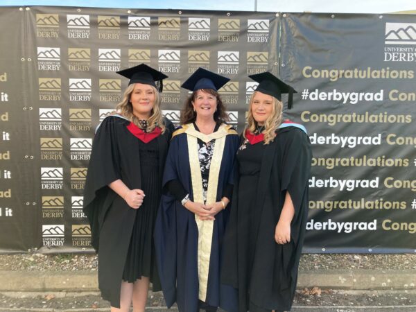 Twins reunited with midwife at graduation ceremony