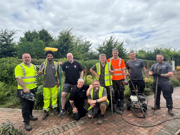 Volunteers help spruce up trust’s homeless project